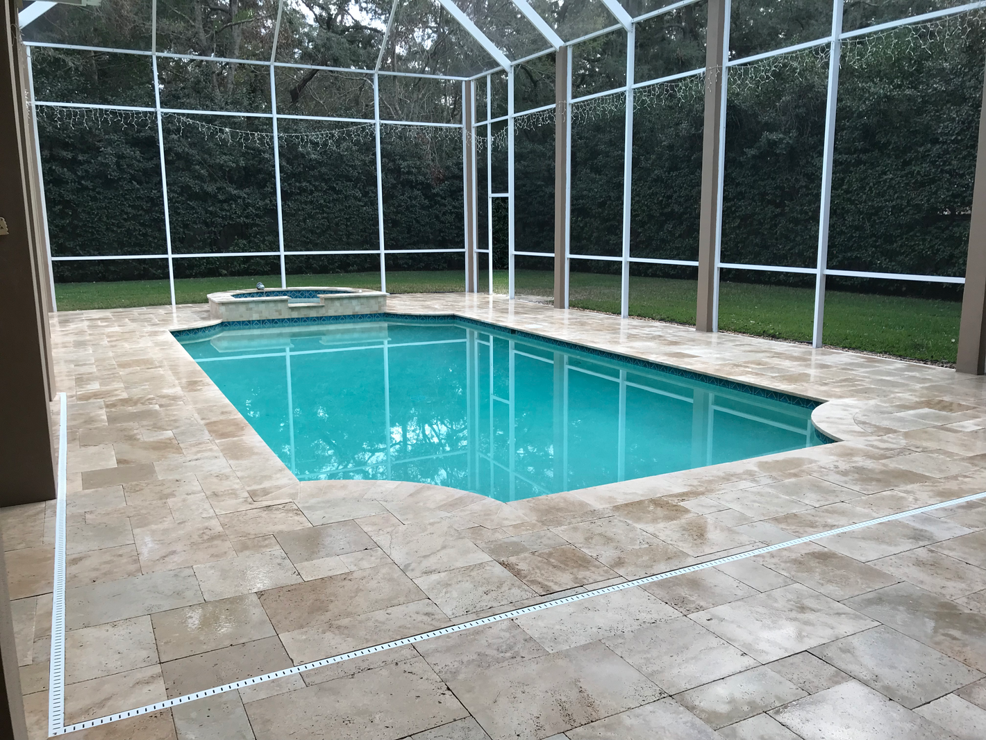Travertine pool deck and coping plus waterfall feature
