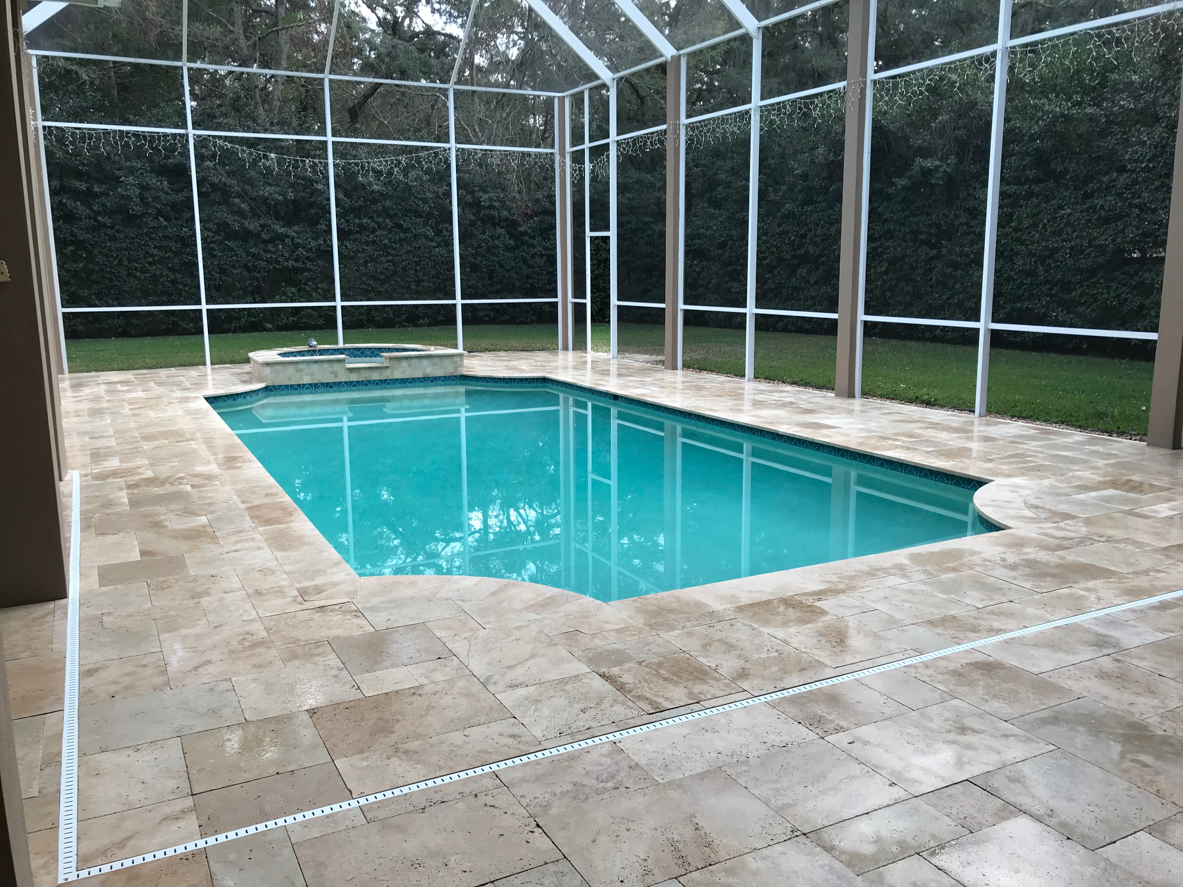 Travertine pool deck and coping plus waterfall feature