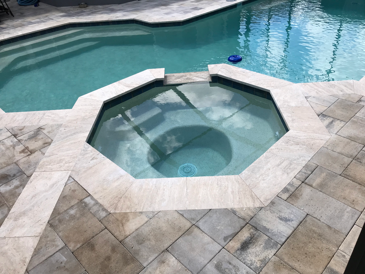 Travertine and paver spa deck and coping