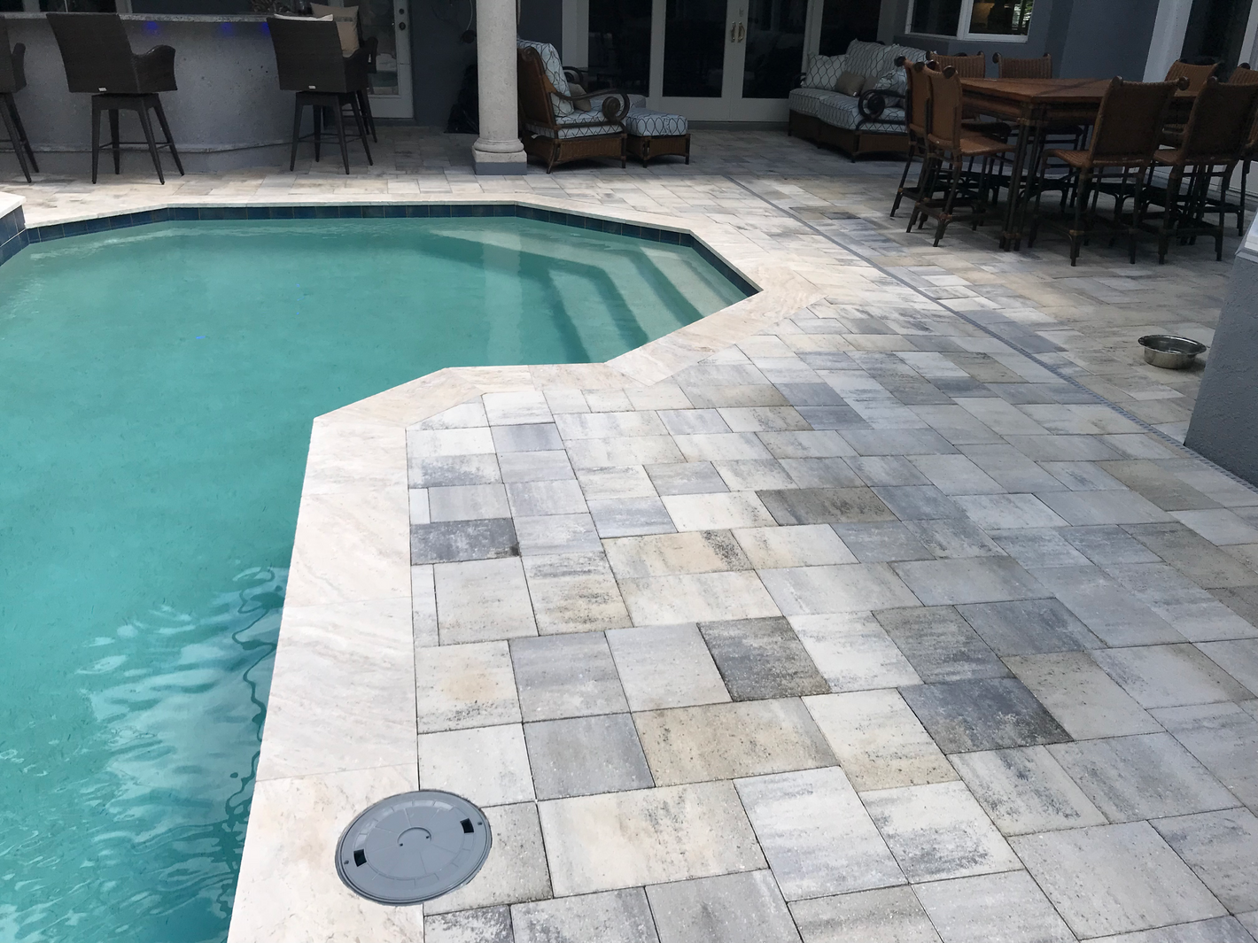 Paver and travertine pool deck and coping