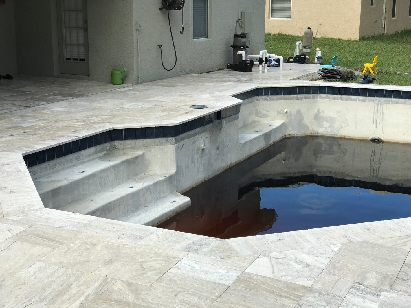 Travertine pool deck and coping plus in-pool tile